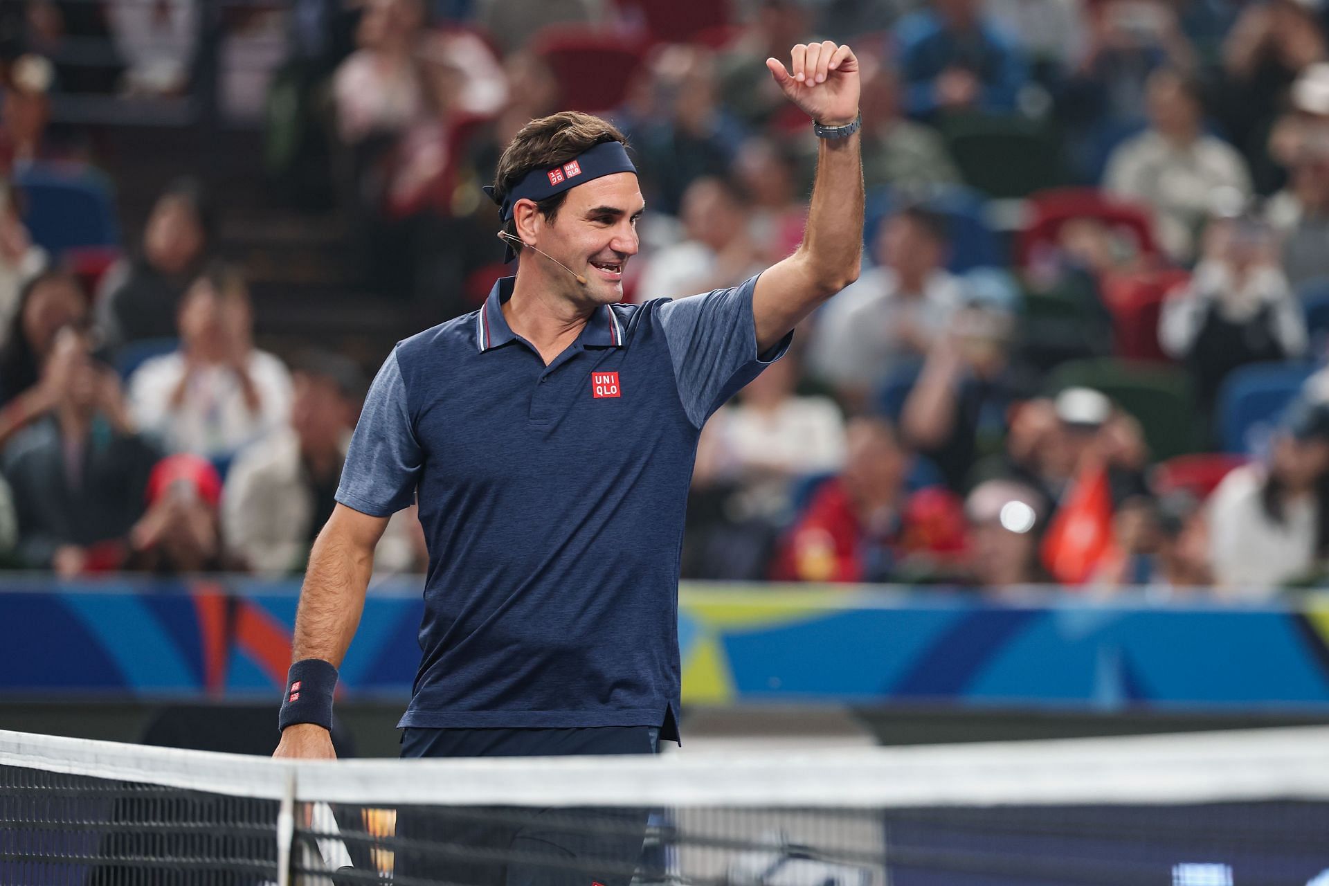The Swiss maestro waves during an exhibition at Shanghai Masters 2024